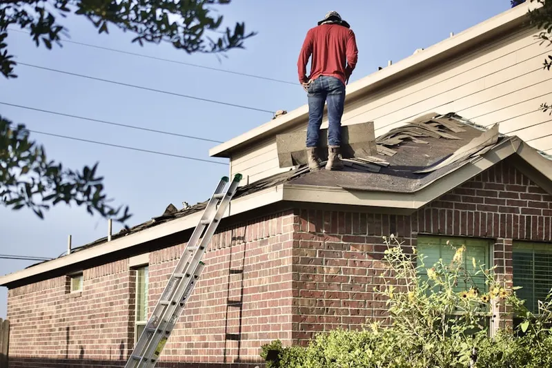 Professional roofer working on a residential roof in Hutchinson Mills